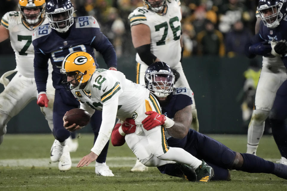 Green Bay Packers quarterback Aaron Rodgers (12) is sacked by Tennessee Titans defensive tackle Jeffery Simmons (98) during the second half of an NFL football game Thursday, Nov. 17, 2022, in Green Bay, Wis. (AP Photo/Morry Gash)