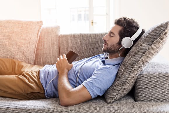 Man listening to music on a couch