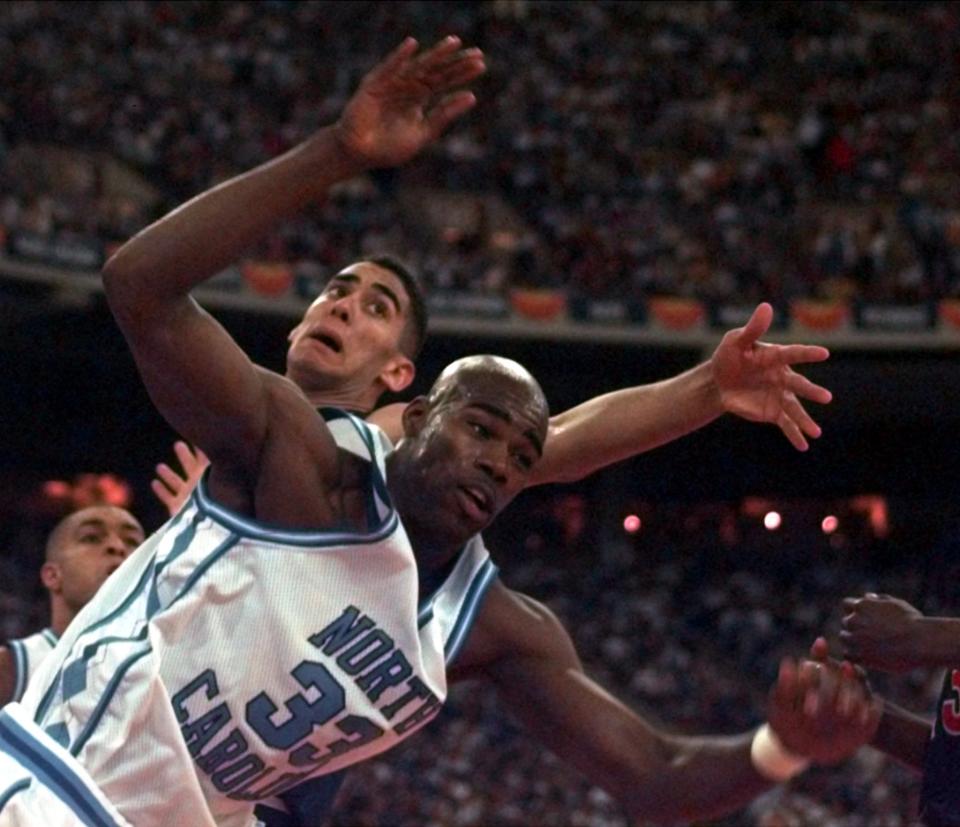 Arizona’s A.J. Bramlett, rear, gets tangled up with North Carolina’s Antawn Jamison (33) during the first half Saturday, March 29, 1997, of the their semifinal game of the NCAA Final Four tournament at the RCA Dome in Indianapolis. AP Photo/Cliff Schiappa