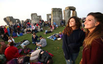 <p>People watch the sun rise on the Stonehenge monument on the summer solstice near Amesbury, Britain, June 21, 2017. (Photo: Neil Hall/Reuters) </p>