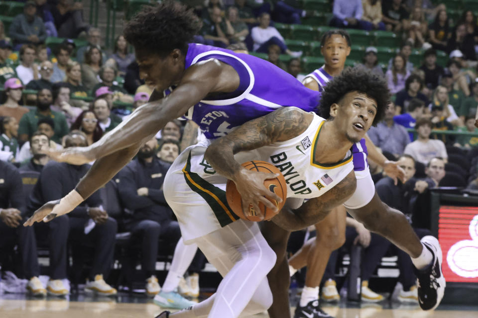 Tarleton State forward KiAndre Gaddy falls ontop of Baylor forward Jalen Bridges in the second half of an NCAA college basketball game, Tuesday, Dec. 6, 2022, in Waco, Texas. (AP Photo, Rod Aydelotte)