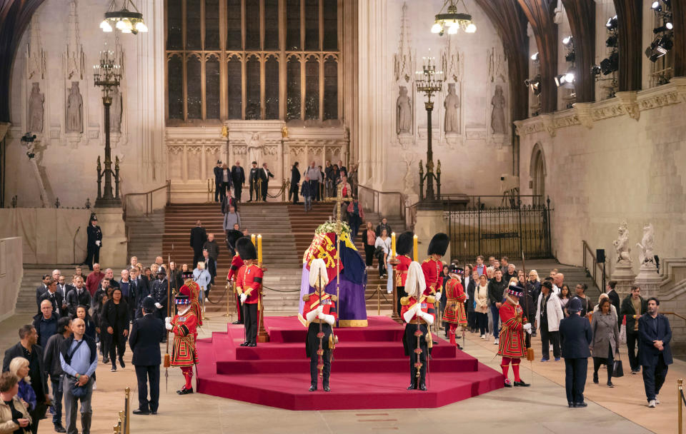 Members of the public file past the coffin of Queen Elizabeth II, draped in the Royal Standard with the Imperial State Crown and the Sovereign's orb and sceptre, lying in state on the catafalque in Westminster Hall, at the Palace of Westminster, in London, Thursday, Sept. 15, 2022, ahead of her funeral on Monday. (Danny Lawson/Pool Photo via AP)