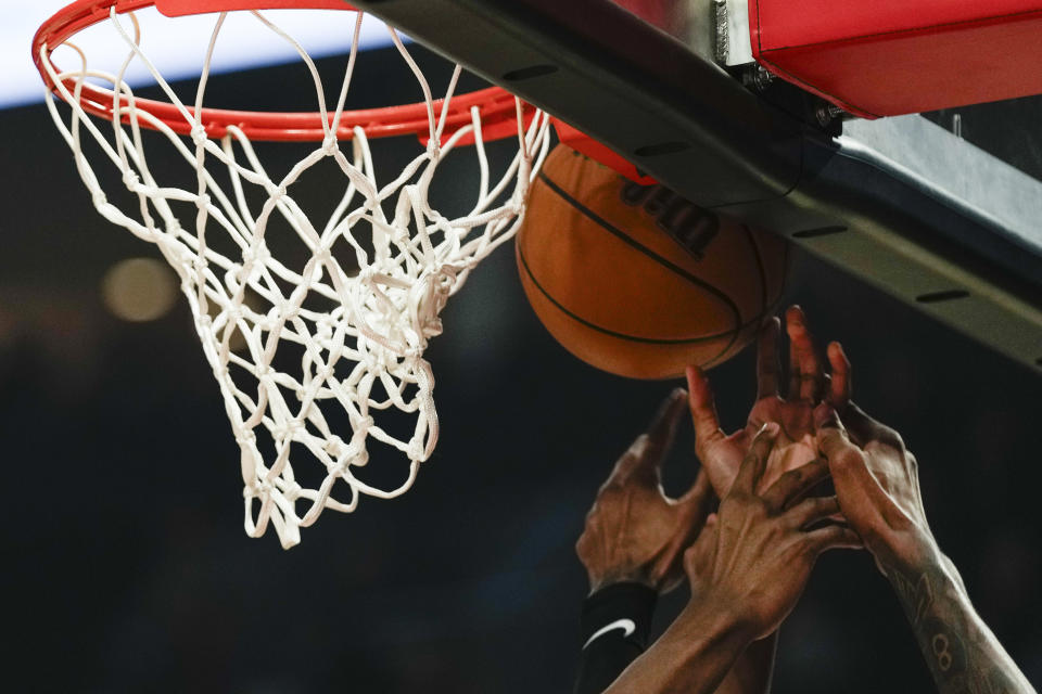 Players go for a rebound during the first half of an NBA basketball game between the Portland Trail Blazers and the Houston Rockets in Portland, Ore., Friday, April 12, 2024. (AP Photo/Jenny Kane)
