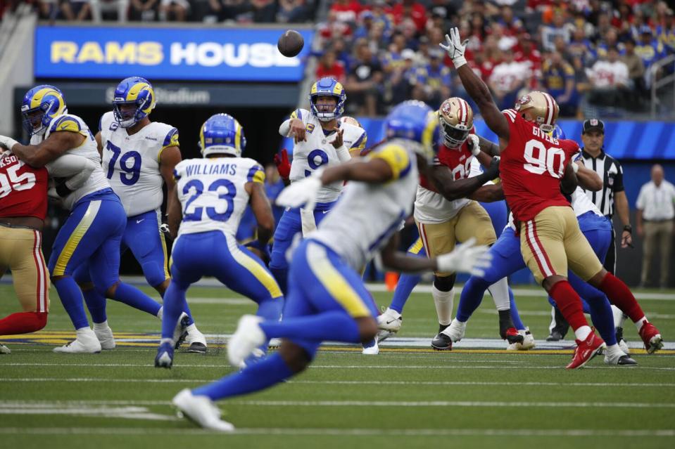 Rams quarterback Matthew Stafford (9) looks to make a short pass to running back Kyren Williams (23).