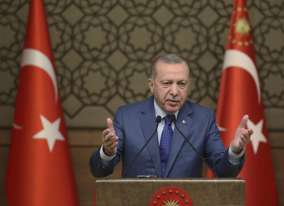 Turkish President Recep Tayyip Erdogan speaks during a meeting at his presidential palace, in Ankara, Turkey, Thursday, Oct. 24, 2019. Erdogan on Thursday renewed a threat to resume its military offensive if his country continued to be "harassed" by the Kurdish militia.( Presidential Press Service via AP, Pool )