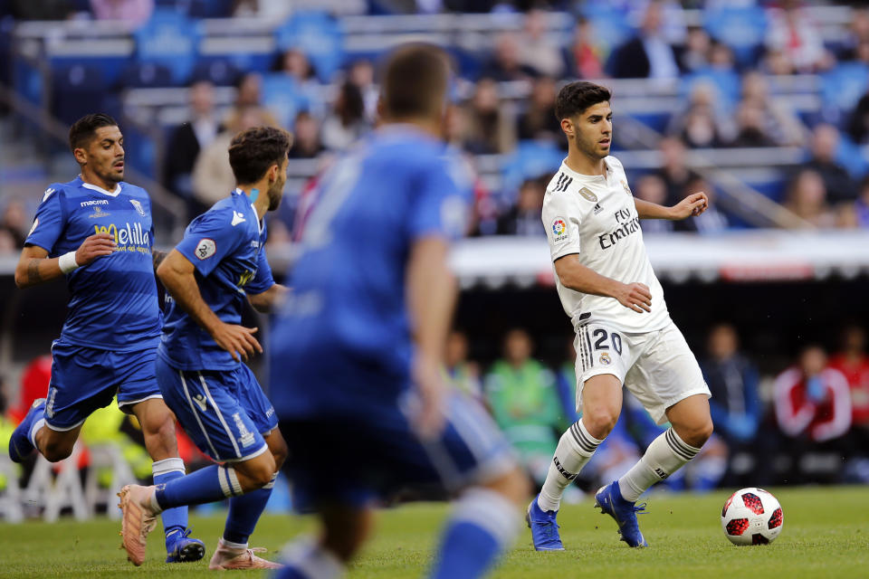 Real Madrid's Marco Asensio, right, controls the ball during a round of 32, 2nd leg, Spanish Copa del Rey soccer match between Real Madrid and Melilla at the Santiago Bernabeu stadium in Madrid, Spain, Thursday, Dec. 6, 2018. (AP Photo/Paul White)