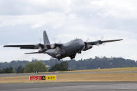 In this photo provided by the New Zealand Defence Force, a Royal New Zealand Air Force C-130 Hercules leaves an airbase in Auckland, Thursday, Jan. 20, 2022, flying to Tonga with aid. The first flight carrying fresh water and other aid to Tonga was finally able to leave Thursday after the Pacific nation's main airport runway was cleared of ash left by a huge volcanic eruption. (CPL Dillon Anderson/New Zealand Defence Force via AP)