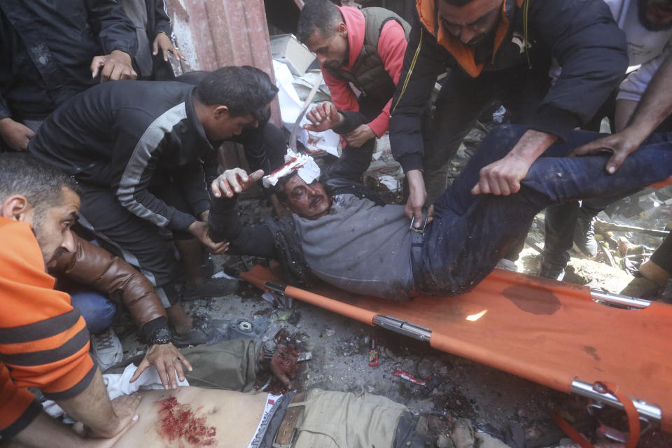 Palestinians rescue survivors after an Israeli strike on Shaheen family house in Rafah, Gaza Strip, Saturday, Feb. 24, 2024. (AP Photo/Hatem Ali)