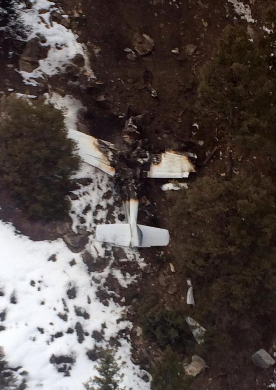 This photo released by the San Miguel Sheriff’s Office shows the wreckage of a private Beechcraft Bonanza single-engine plane that crashed near a Colorado ski town's airport, killing all three people aboard. Sheriff's spokeswoman Jennifer Dinsmore said deputies began the recovery effort west of Telluride, Colo., Monday Feb. 17, 2014. The airplane took off from Telluride Regional Airport on Sunday, Feb. 16 on its way to Cortez, a city in southwest Colorado about 75 miles away. (AP Photo/San Miguel Sheriff’s Office)