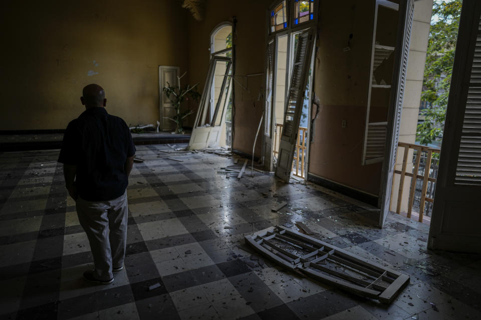 Rev. Barbaro Abel Marrero Castellanos, president of the Baptist Convention of Western Cuba, walks inside the Calvary Baptist Church damaged by an explosion that devastated the Hotel Saratoga which is located next door, in Old Havana, Cuba, Wednesday, May 11, 2022. “We still don't know exactly the magnitude of the damage," said Marrero Castellanos, adding that some specialists have said they might have to evaluate possibly demolishing parts of the structure. (AP Photo/Ramon Espinosa)