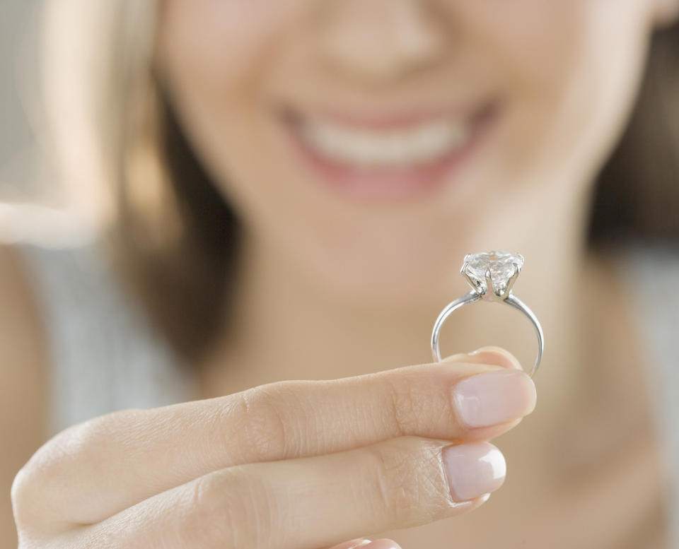 hand holding up an engagement ring