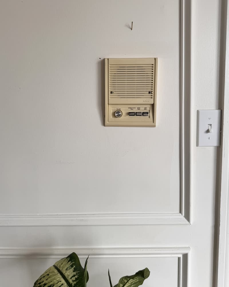 hallway with yellowed old intercom