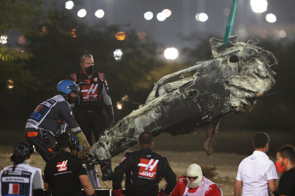 BAHRAIN, BAHRAIN - NOVEMBER 29: Track marshals clear the debris following the crash of Romain Grosjean of France and Haas F1 during the F1 Grand Prix of Bahrain at Bahrain International Circuit on November 29, 2020 in Bahrain, Bahrain. (Photo by Tolga Bozoglu - Pool/Getty Images)