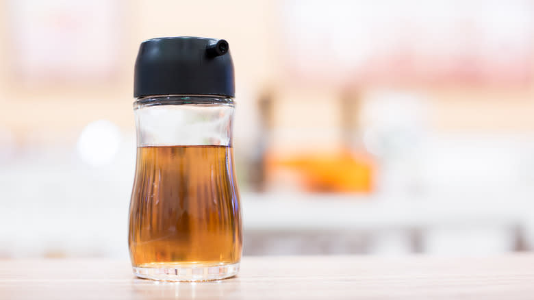 Bottle of fish sauce on table