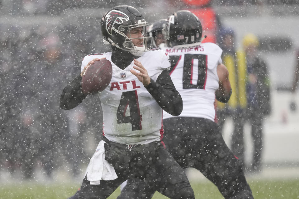 Atlanta Falcons quarterback Taylor Heinicke (4) looks to pass in the first half of an NFL football game against the in Chicago, Sunday, Dec. 31, 2023. (AP Photo/Charles Rex Arbogast)