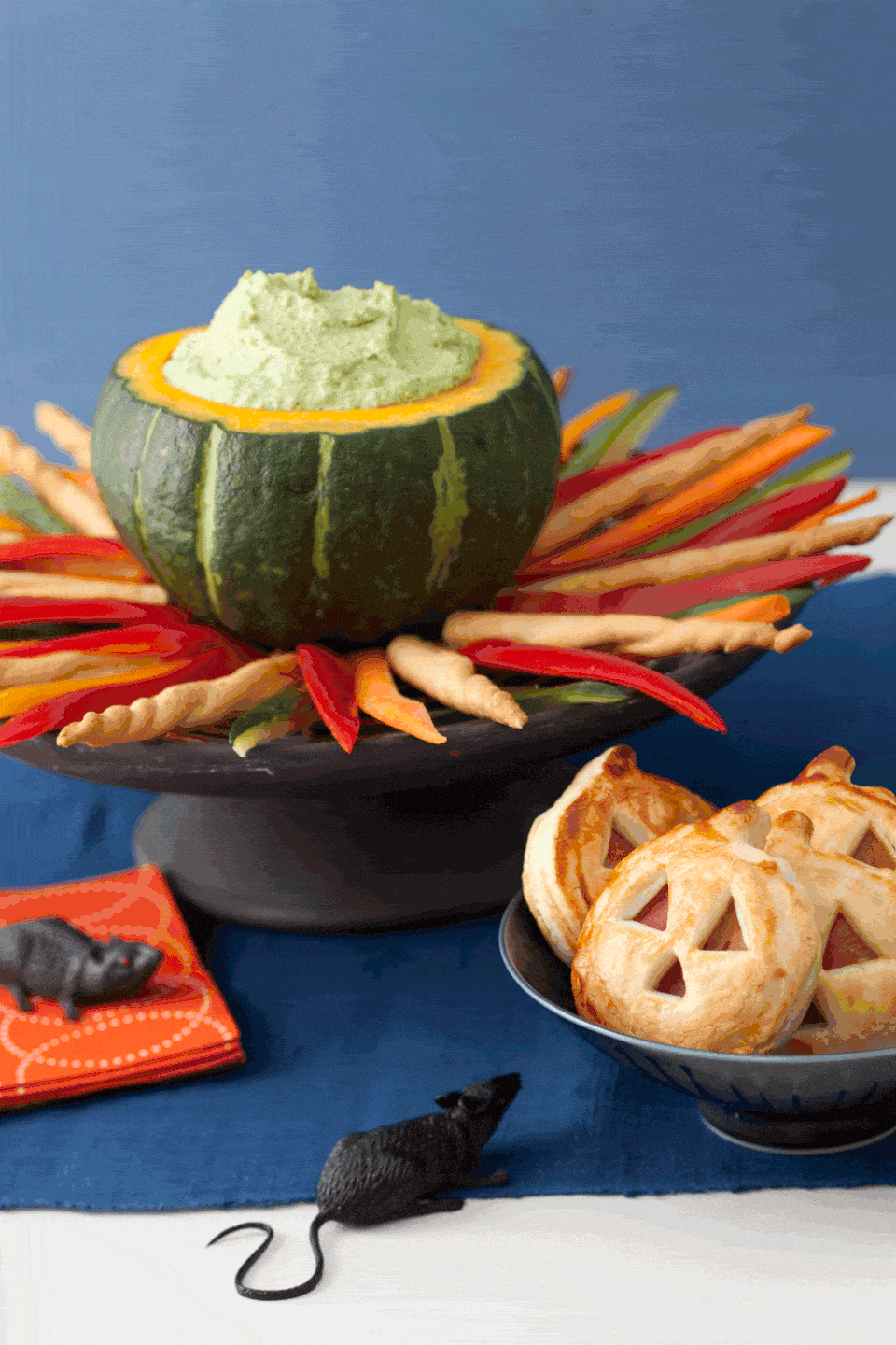 <p>Made from edamame and low-fat ricotta cheese, this tasty green dip looks even cooler when served in a hollowed-out acorn squash and surrounded by a "fire" of crudité and breadsticks.</p><p>Get the <strong><a href="https://www.womansday.com/food-recipes/food-drinks/recipes/a11350/cauldron-dip-recipe-122710/" rel="nofollow noopener" target="_blank" data-ylk="slk:Cauldron Dip recipe" class="link ">Cauldron Dip recipe</a></strong>.</p>
