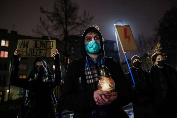 PHOTO: People wear a protective face masks and hold banners and candles during a protest in front of the Law and Justice party office on Jan. 26, 2022 in Krakow, Poland. (Omar Marques/Getty Images, FILE)