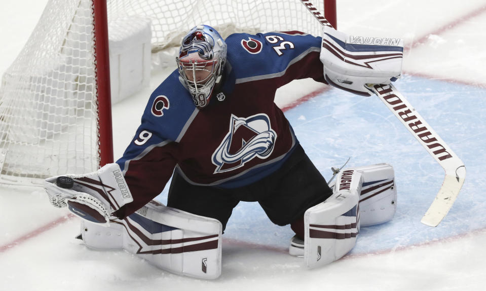 Colorado Avalanche goaltender Pavel Francouz gloves the puck, against the Pittsburgh Penguins during the third period of an NHL hockey game Friday, Jan. 10, 2020, in Denver. Pittsburgh won 4-3 in overtime. (AP Photo/David Zalubowski)