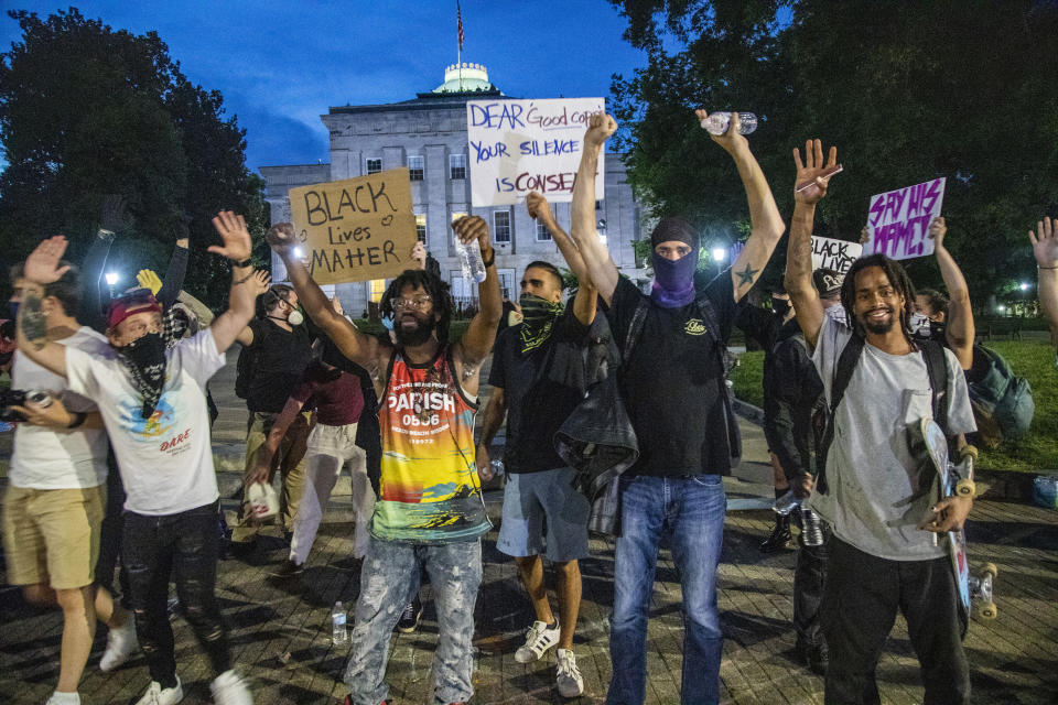 FILE - Protesters peacefully disperse one hour after curfew on June 1, 2020, in downtown Raleigh, N.C., during protests over the death of George Floyd. A North Carolina civil rights group filed a federal lawsuit on Tuesday, April 11, 2023, challenging a new state law that will increase punishments for violent protests in response to the nationwide 2020 racial injustice demonstrations ignited by George Floyd’s murder. (Travis Long/The News & Observer via AP, File)