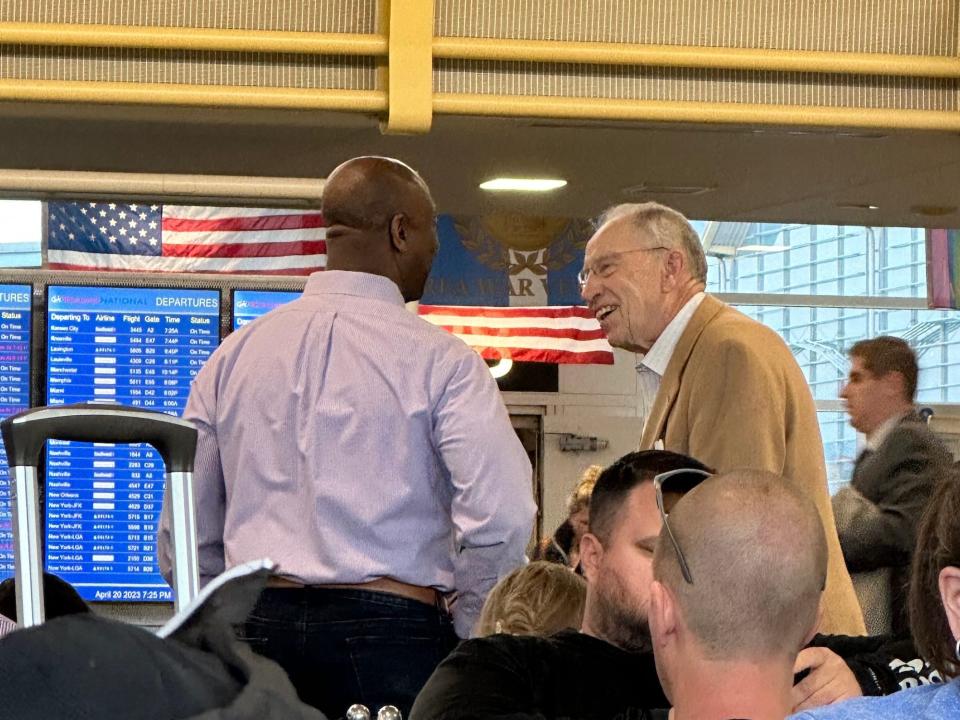 Sen. Chuck Grassley speaks with Sen. Tim Scott at Reagan National Airport near Washington, DC on April 20, 2023.