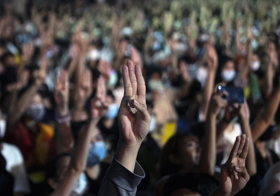 Pro-democracy students raise a three-finger symbol of resistance salute during a protest at the Thammasat University in Pathum Thani, north of Bangkok, Thailand, Monday, Aug, 10, 2020. Protesters warned that they'll step up pressure on the government if it failed to meet their demands, which include dissolving the parliament, holding new elections and changing the constitution. (AP Photo/Sakchai Lalit)