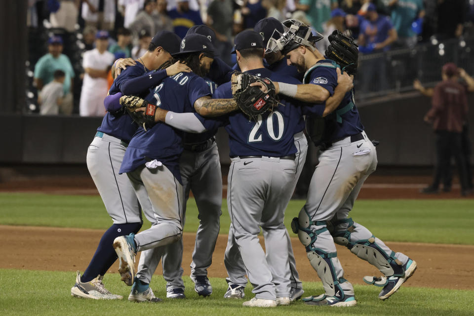 Seattle Mariners players celebrate after defeating the New York Mets in a baseball game, Saturday, Sept. 2, 2023, in New York. (AP Photo/Jason DeCrow)