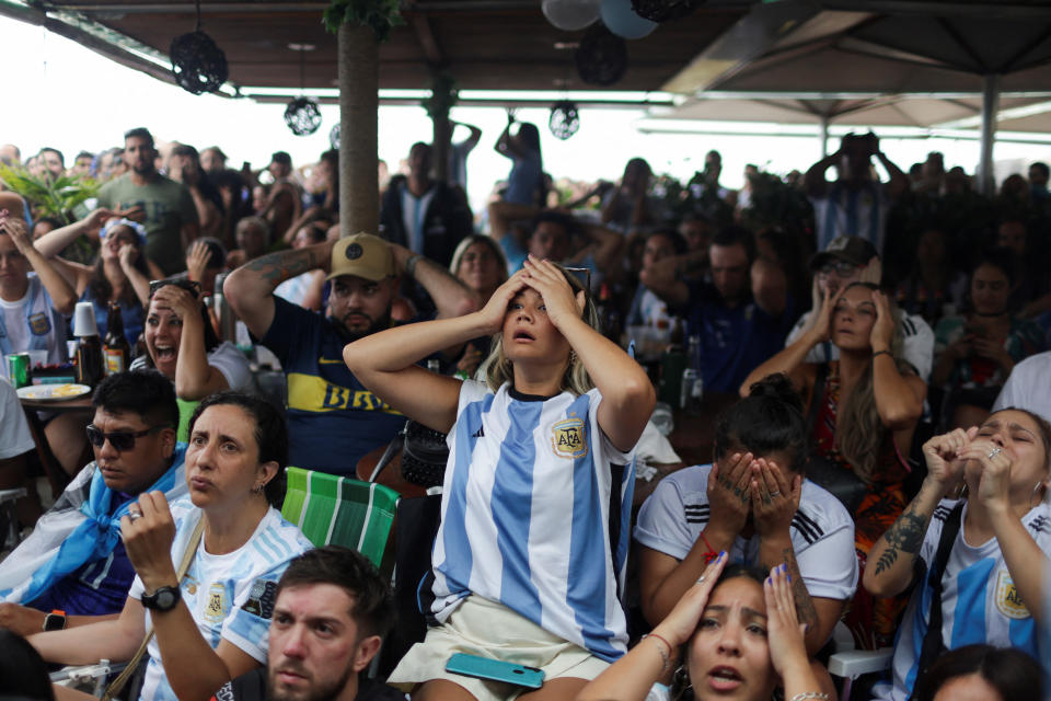 An Argentinian fan reacts as people watch the FIFA World Cup Qatar 2022 final match between Argentina and France at the Buenos Aires bar in Copacabana beach, in Rio de Janeiro, Brazil, December 18, 2022. REUTERS/Pilar Olivares