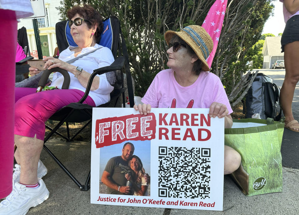 Supporters of Karen Read display signs near Norfolk Superior Court, Tuesday, June 25, 2024, in Dedham, Mass. Read is on trial, accused of killing her boyfriend Boston Police Officer John O'Keefe, in 2022. The jury began deliberations in the trial Tuesday. (AP Photo/Nick Perry)