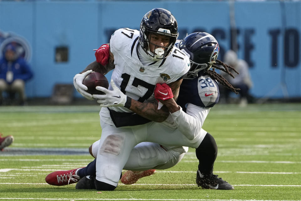 Jacksonville Jaguars tight end Evan Engram (17) is tackled after a catch by Tennessee Titans safety Terrell Edmunds (38) during the second half of an NFL football game Sunday, Jan. 7, 2024, in Nashville, Tenn. (AP Photo/George Walker IV)