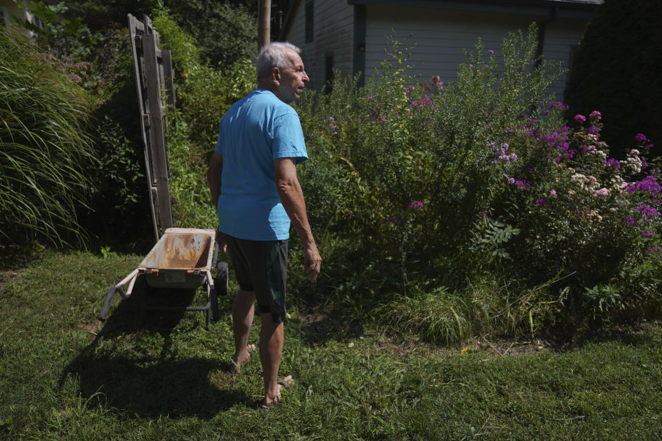 Mike Dulak walks through the large garden surrounding his home in Rocheport, Mo., Friday, Sept. 8, 2023. Dulak does not associate with any religious group and self-identifies as "nothing in particular" when asked about his beliefs. He is part of the largest growing group of nonbelievers in the United States today, as nearly one in six adults claim the label "nothing in particular" according to the Associated Press- NORC Center for Public Affairs Research. (AP Photo/Jessie Wardarski)