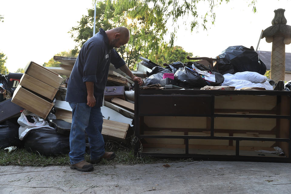 Ernesto Ramirez pauses as he cleans out his house.