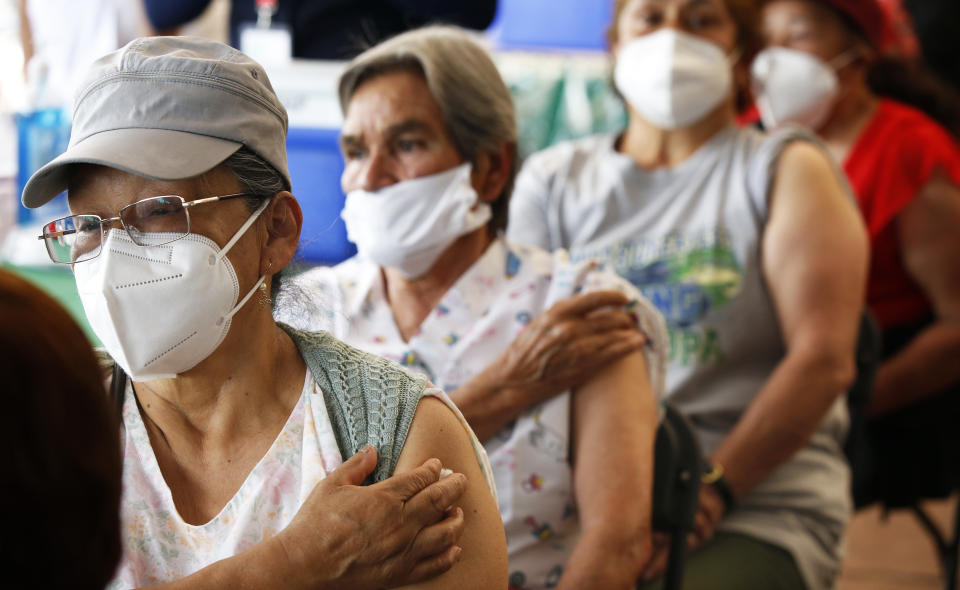 Persons over 60-years-old wait in observation after receiving their second dose of the AstraZeneca COVID-19 vaccine at the University Olympic Stadium in Mexico City, Monday, April 12, 2021. (AP Photo/Marco Ugarte)