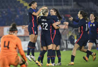 United States players run to celebrate with Kristie Mewis, number 22, who scored her side's second goal during the international friendly women's soccer match between The Netherlands and the US at the Rat Verlegh stadium in Breda, southern Netherlands, Friday Nov. 27, 2020. (Piroschka van de Wouw/Pool via AP)
