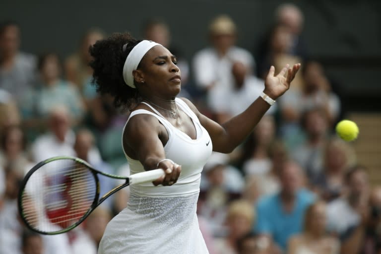 US player Serena Williams returns against Hungary's Timea Babos during their women's singles second round match on day three of the 2015 Wimbledon Championships in southwest London, on July 1, 2015