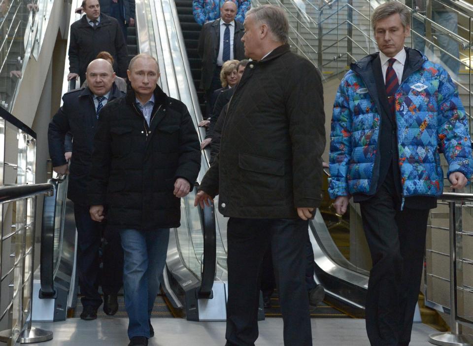 Russian President Vladimir Putin, foreground left, and Railways Chief Vladimir Yakunin, second right, visit the Olympic Park railway station at the Black Sea resort of Sochi, southern Russia, Saturday, Jan. 4, 2014. Russian President Vladimir Putin has rescinded a blanket ban on demonstrations in Sochi in and around the Winter Olympics and Paralympics. (AP Photo/RIA-Novosti, Alexei Nikolsky, Presidential Press Service)