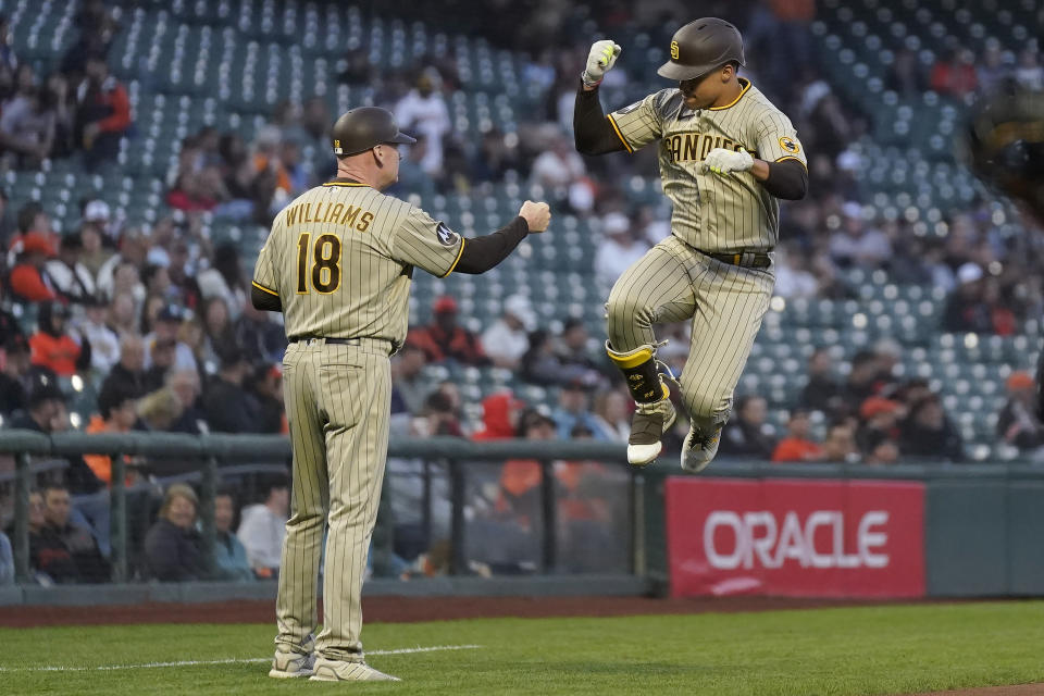 San Diego Padres' Juan Soto, right, celebrates with third base coach Matt Williams (18) after hitting a home run against the San Francisco Giants during the first inning of a baseball game in San Francisco, Tuesday, Sept. 26, 2023. (AP Photo/Jeff Chiu)