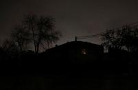 A light shines from inside a house in a neighbourhood without electricity after a massive blackout in Argentina, in Montevideo