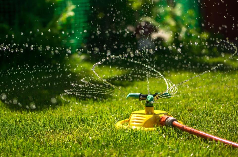 A close up of a lawn sprinkler in action. 