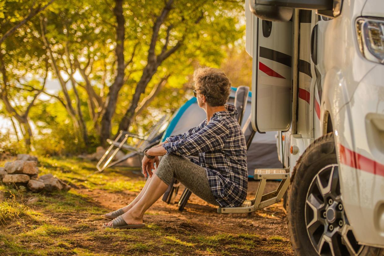 woman relaxing enjoying nature outside rv