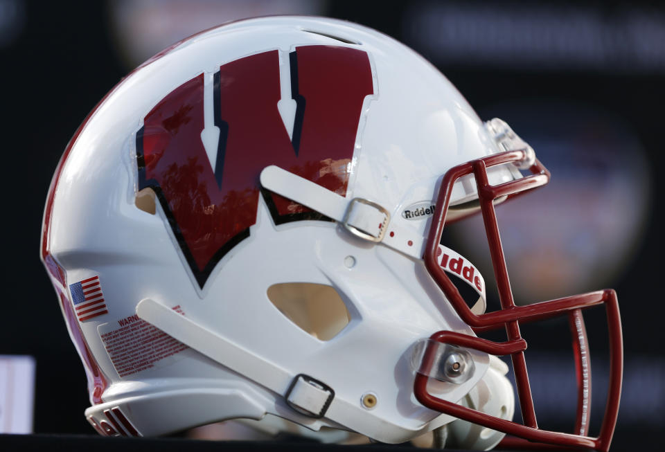 A Wisconsin football helmet is shown before a news conference, Wednesday, Dec. 6, 2017 in Hollywood, Fla. Wisconsin will play Miami Dec. 30 in the Orange Bowl at Hard Rock Stadium in Miami Gardens, Fla. (AP Photo/Wilfredo Lee)