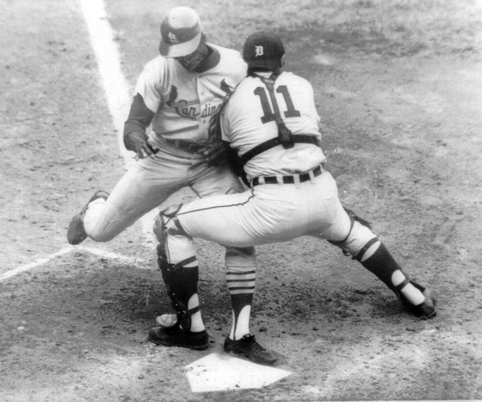 FILE - Detroit Tigers catcher Bill Freehan puts the tag on Lou Brock of the St. Louis Cardinals at the plate in the fifth inning of fifth game of World Series at Detroit's Tiger Stadium, in this Oct. 7, 1968 file photo. Freehan, an 11-time All-Star catcher with the Detroit Tigers and key player on the 1968 World Series championship team, has died at age 79. “It’s with a heavy heart that all of us with the Detroit Tigers extend our condolences to the friends and family of Bill Freehan,” the team said Thursday, Aug. 19, 2021. (AP Photo/File)