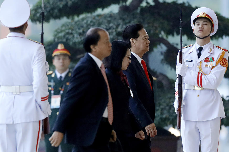 Former Vietnam's Prime Minister Nguyen Tan Dung, second right, arrives for the opening ceremony of the 13th National Congress of Vietnam's Communist Party (VCP), in Hanoi, Vietnam, Tuesday, Jan. 26, 2021. (AP Photo/Minh Hoang)