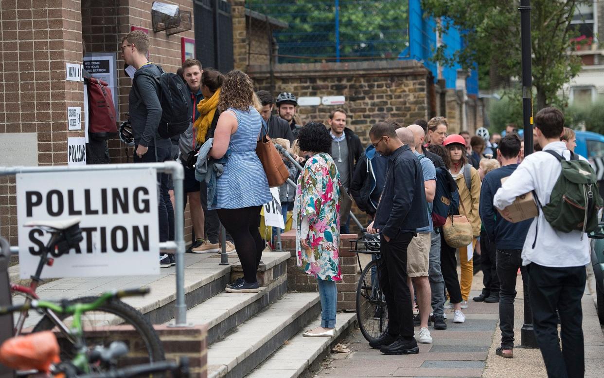 People queue to cast their vote at a Polling station in Peckham South London. - Eddie Mulholland