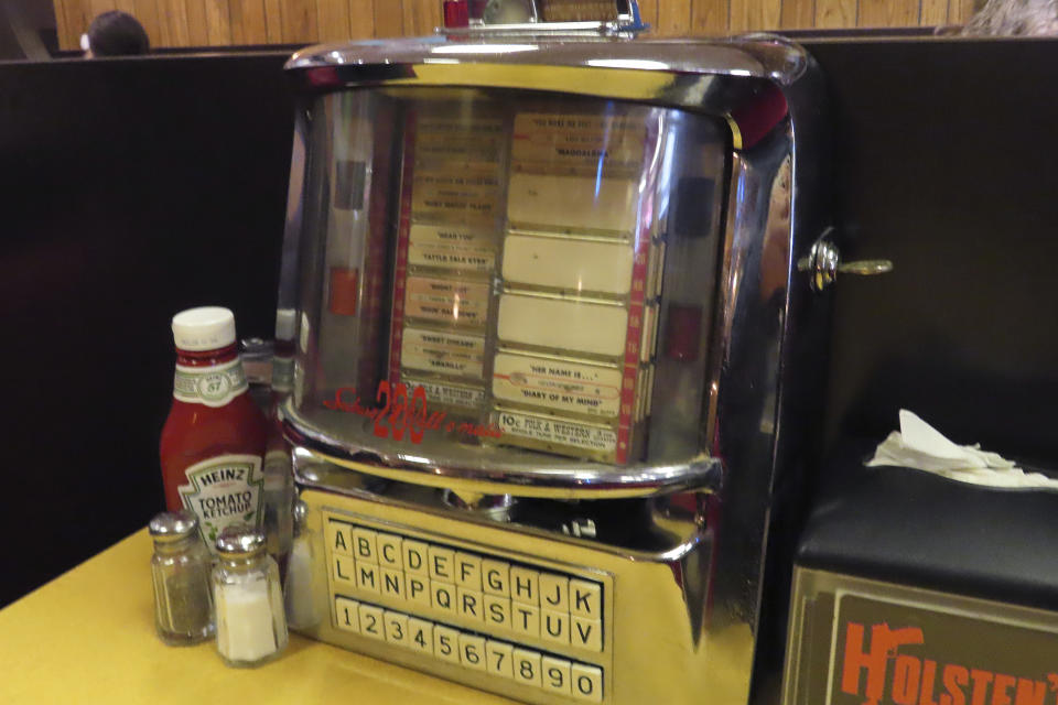 A jukebox at Holsten's, the Bloomfield N.J. ice cream parlor and restaurant where the final scene of "The Sopranos" TV series was filmed, sits on March 5, 2024, at a recreation of the booth where Tony Soprano may or may not have met his end. The day before, the original booth used in the show was was sold in an online auction for $82,600 to a buyer that wishes to remain anonymous. (AP Photo/Wayne Parry)