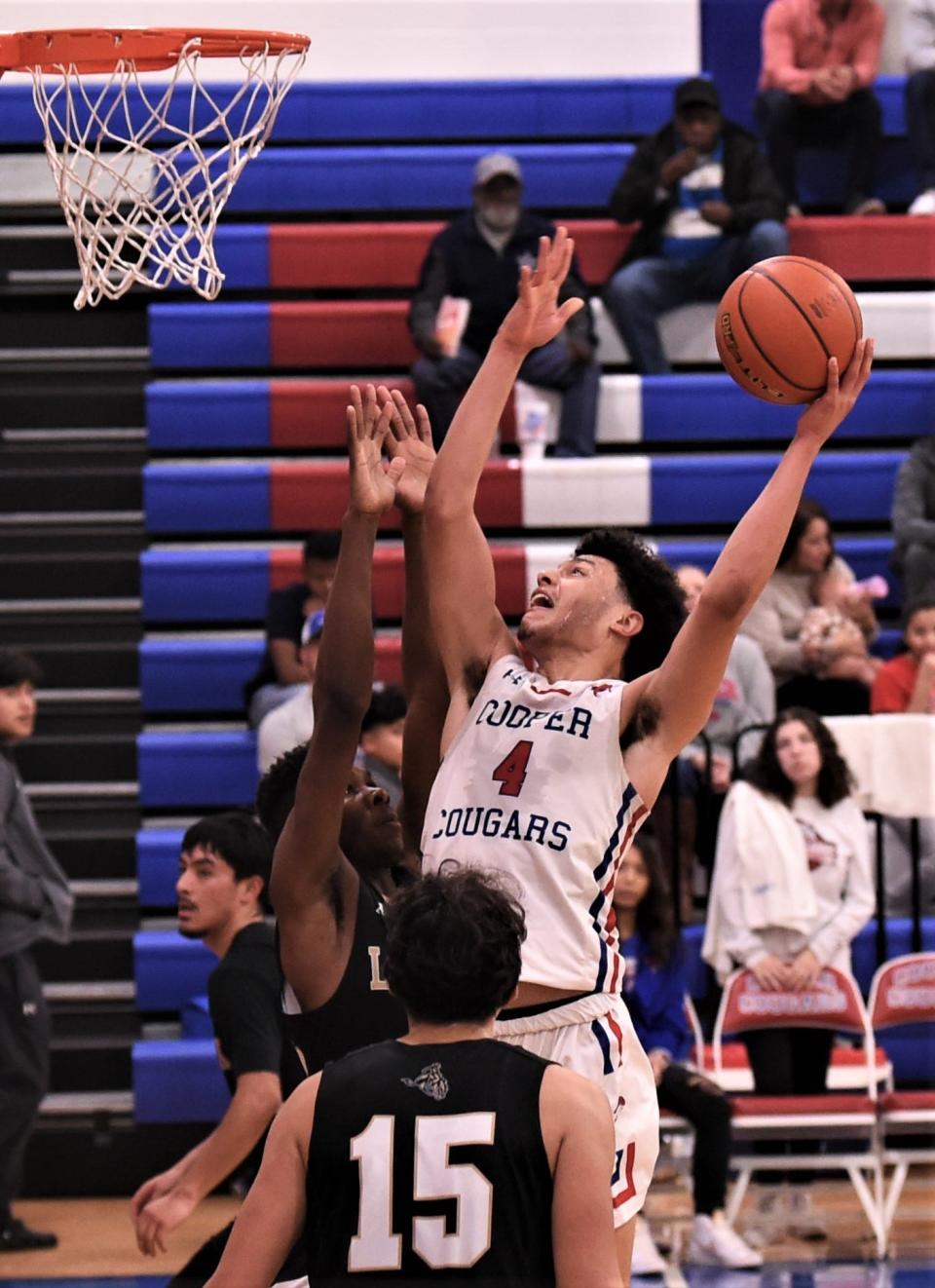 Cooper's Jaelyn Rivera (4) drives to the basket against the Lubbock High defense in the second half.