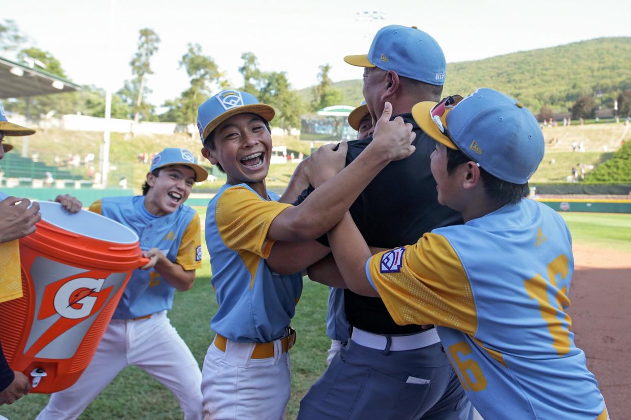 Players from the West Region team from Honolulu, Hawaii celebrate after winning against the Caribbean Region team from Willemstad, Curacao 13-3 at Little League International Complex on August 28, 2022 in South Williamsport, Pennsylvania.