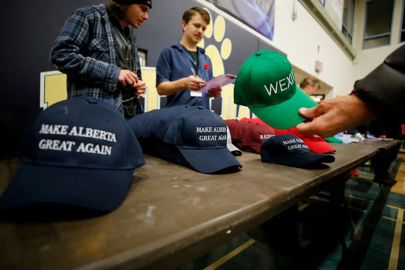 FILE PHOTO: A man buys a hat to raise funds at a rally for Wexit Alberta, a separatist group seeking federal political party status, in Calgary