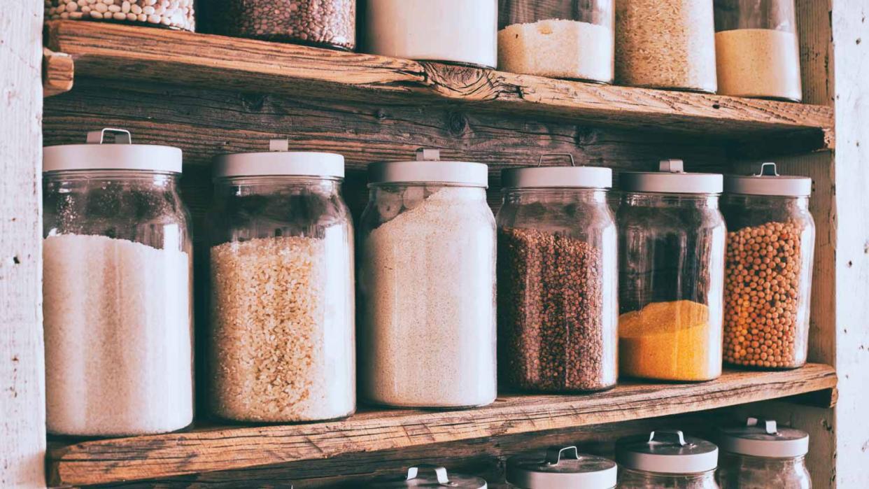 Food storage containers on wooden shelves