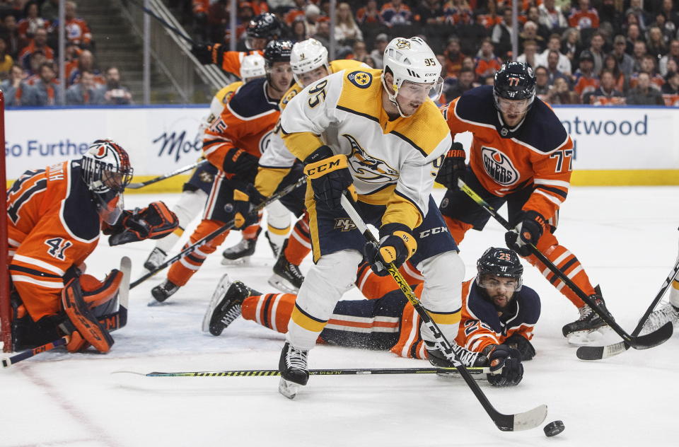 Nashville Predators' Matt Duchene (95) is chased by the Edmonton Oilers during third-period NHL hockey game action in Edmonton, Alberta, Saturday, Feb. 8, 2020. (Jason Franson/The Canadian Press via AP)