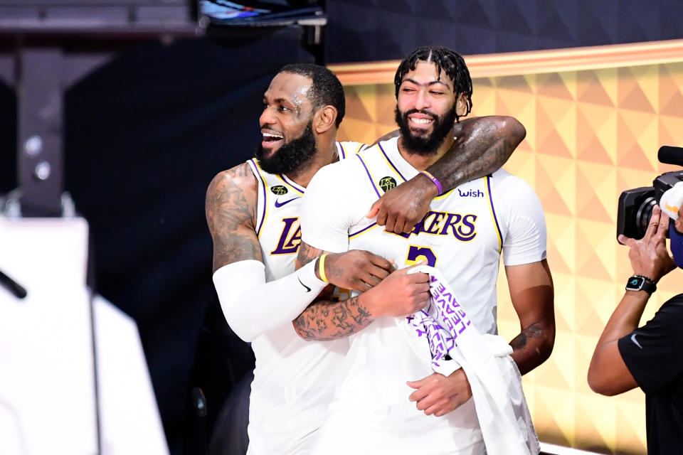 LeBron James #23 of the Los Angeles Lakers and Anthony Davis #3 of the Los Angeles Lakers react after winning the 2020 NBA Championship in Game Six of the 2020 NBA Finals.